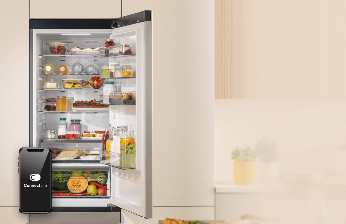 Otwarta chłodziarka Gorenje BigVolume wypełniona produktami oraz ekran smartfona z nazwą aplikacji ConnectLife